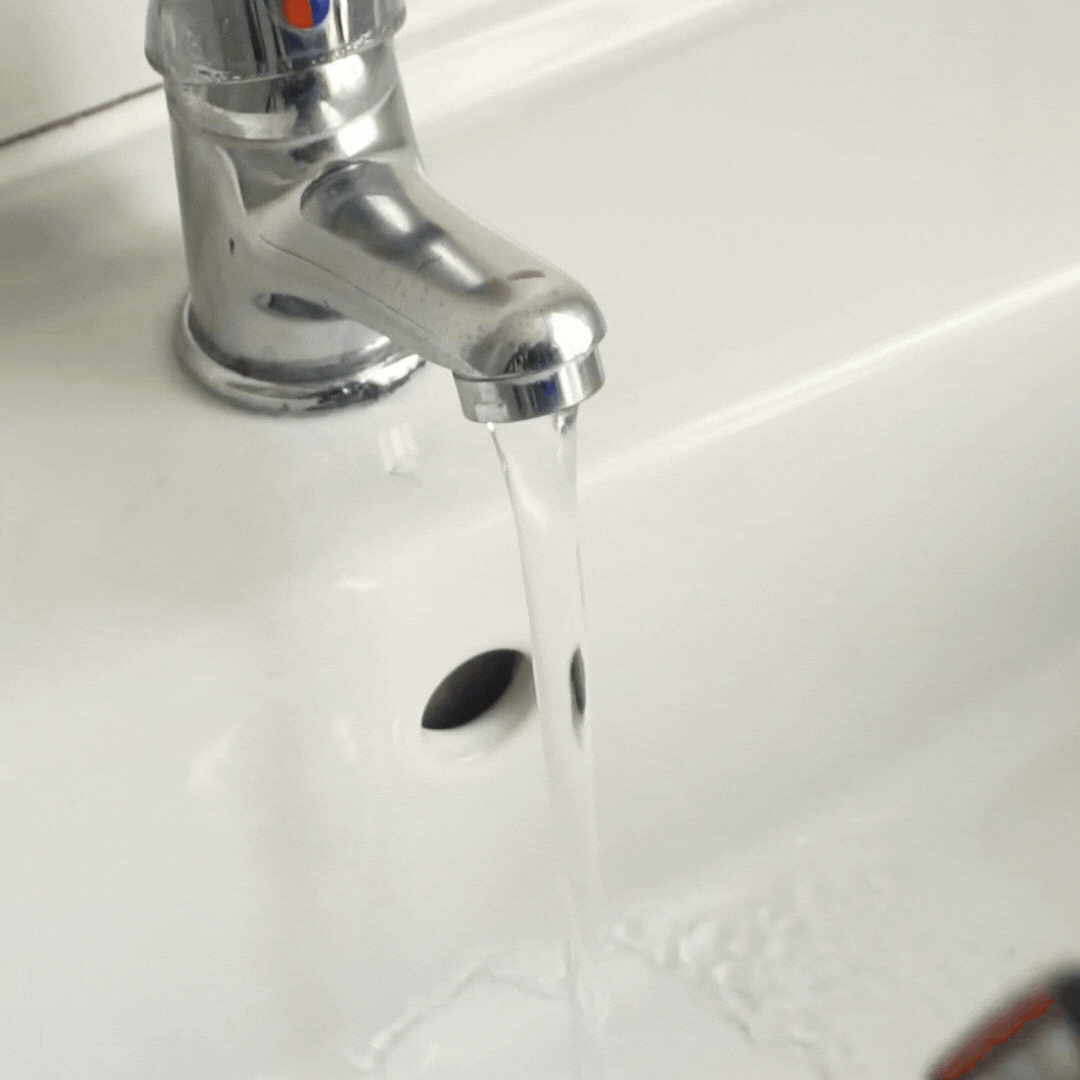 Razor being rinsed under running water after cleaning